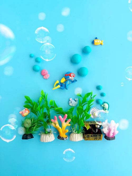 Under the sea sensory play set with blue playdough balls, marine animals, coral reef pieces and ocean plants styled for tactile small world play