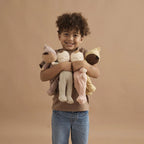 child holding collection of original dozy dinkums