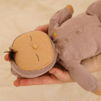 Child holding Pip Dozy Dinkum doll soft baby toy