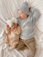 Blossom and Pear knitted baby romper in soft Pink Lemonade colour with frill detailing