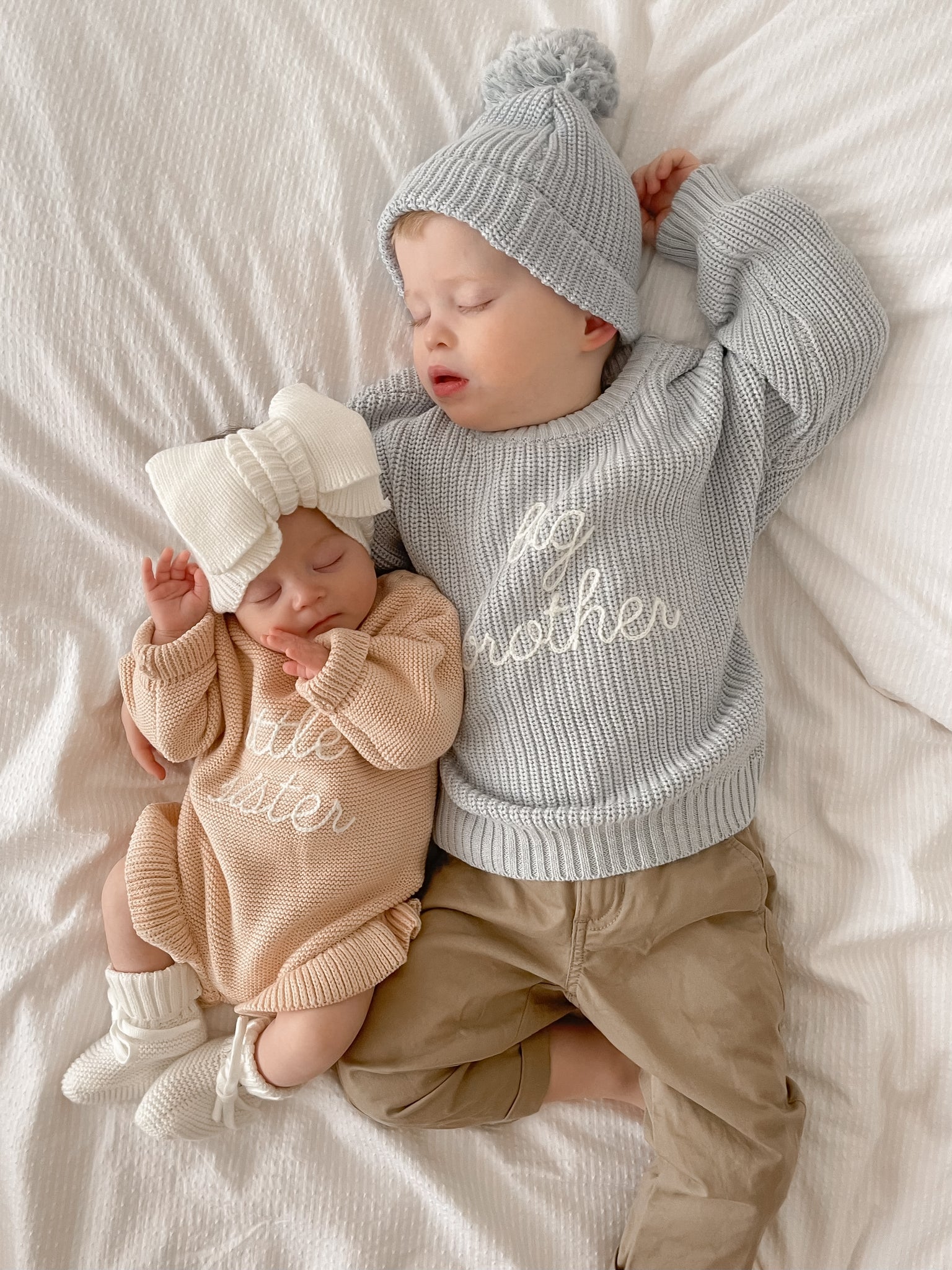 Blossom and Pear knitted baby romper in soft Pink Lemonade colour with frill detailing
