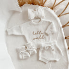 Hello World long sleeve bow announcement bundle by Blossom and Pear with knit sweater shorts booties and bow headband