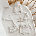 Hello World long sleeve announcement bundle by Blossom and Pear with knit sweater shorts booties and pom pom beanie