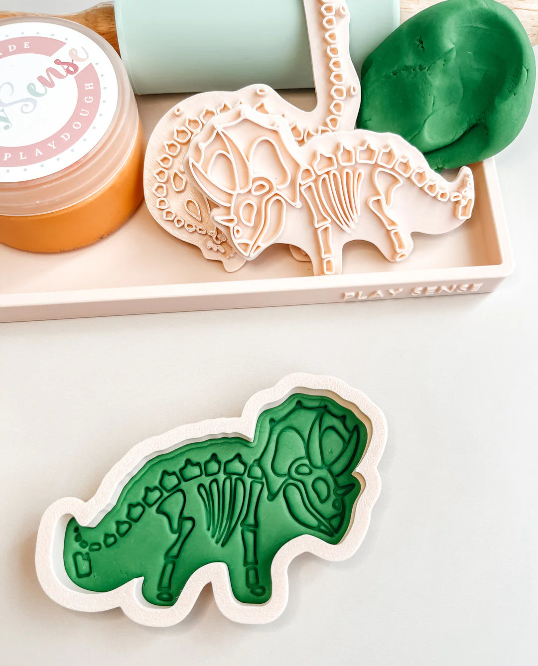 how to use image of playdough/clay stamp and cutter. Eco-friendly sensory play tool by brand playsense perfect for creative and imaginative play. can also be used for cookies and baking. pictured is triceratops dino