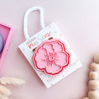 photoshoot image of playdough/clay stamp and cutter. Eco-friendly sensory play tool by brand playsense perfect for creative and imaginative play. can also be used for cookies and baking. pictured is poppy flower