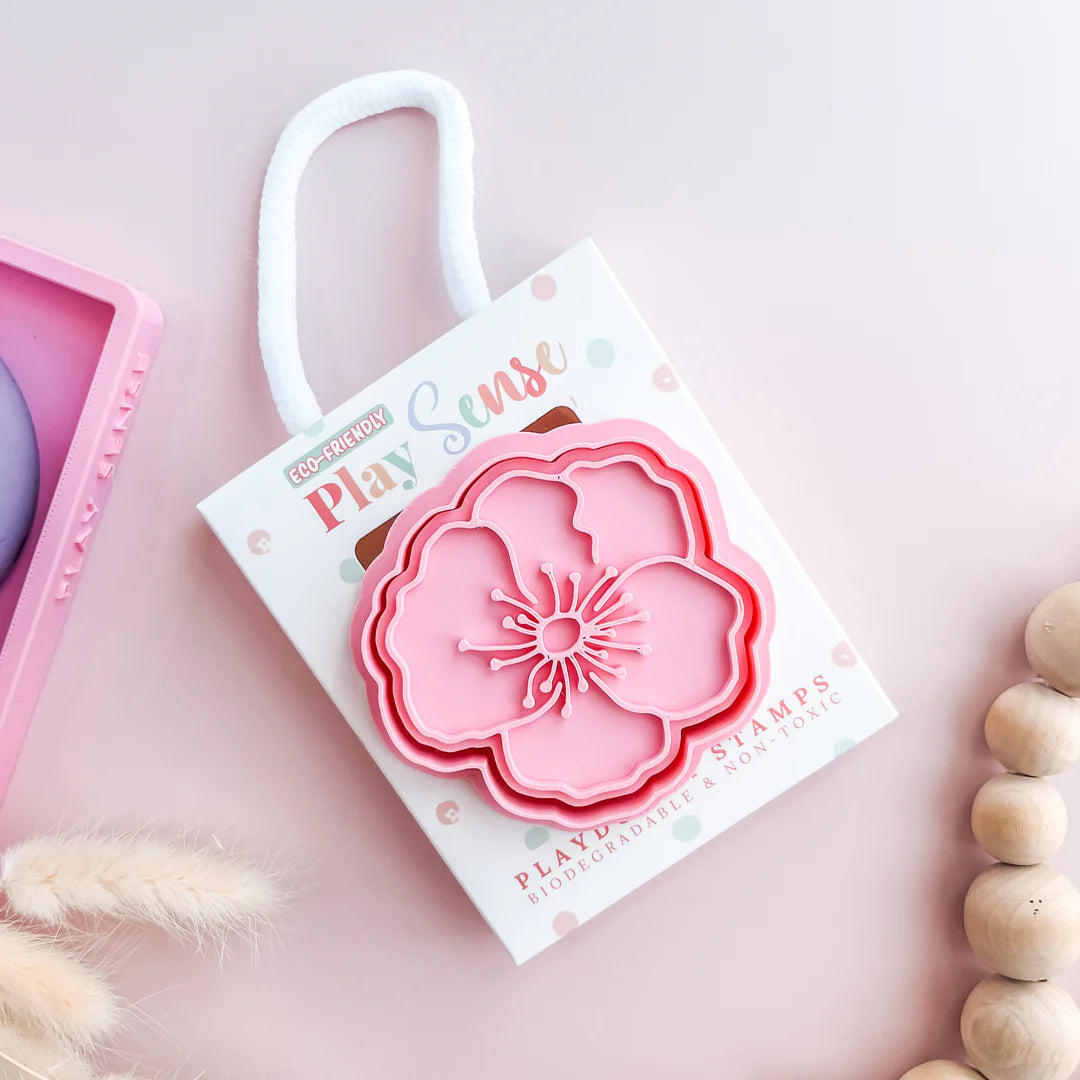 photoshoot image of playdough/clay stamp and cutter. Eco-friendly sensory play tool by brand playsense perfect for creative and imaginative play. can also be used for cookies and baking. pictured is poppy flower
