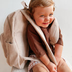 kid toddler wearing Corduroy kids backpack with front pocket, laptop sleeve, health label, name label, options to personalise a name with embroidery, spacious. perfect for school or travel. this colour is latte