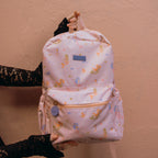adult holding Fox & Fallow backpack for kids, perfect for school, daycare and everyday use. Spacious, practical and designed for little adventures. Personalisation of embroidery with name also available on bags in 2 placements. This print is mermaids