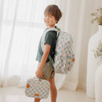 lifestyle kid wearing Fox & Fallow sage check backpack kids school bag
