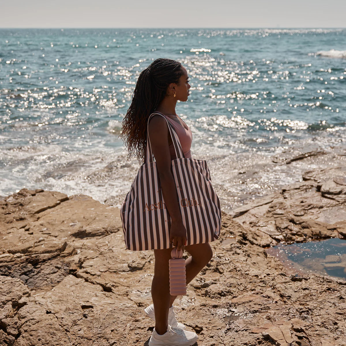 Fox & Fallow weekend tote bag worn at the beach with striped design
