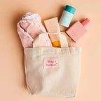 set up in the canvas bag  the tiny harlow bath accessory pack that comes with a bag, body lotion,baby doll towel, baby powder and bubble bath all for pretend play with dolls called tiny bath time