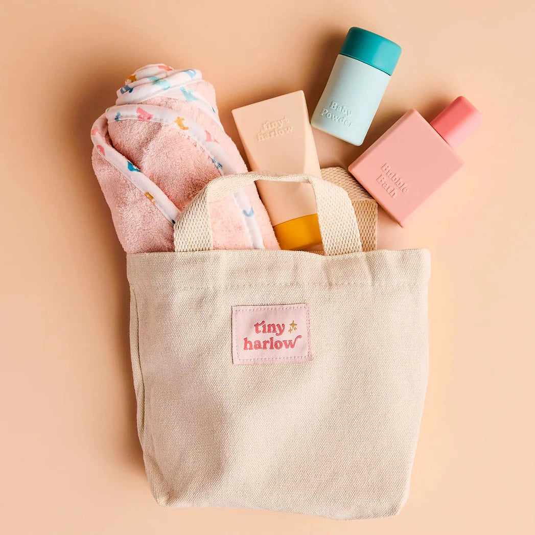 set up in the canvas bag  the tiny harlow bath accessory pack that comes with a bag, body lotion,baby doll towel, baby powder and bubble bath all for pretend play with dolls called tiny bath time