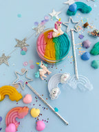 Rainbow unicorn playdough sensory set with layered dough, star wand, pastel sprinkles, stars and charms arranged for creative small world pretend play