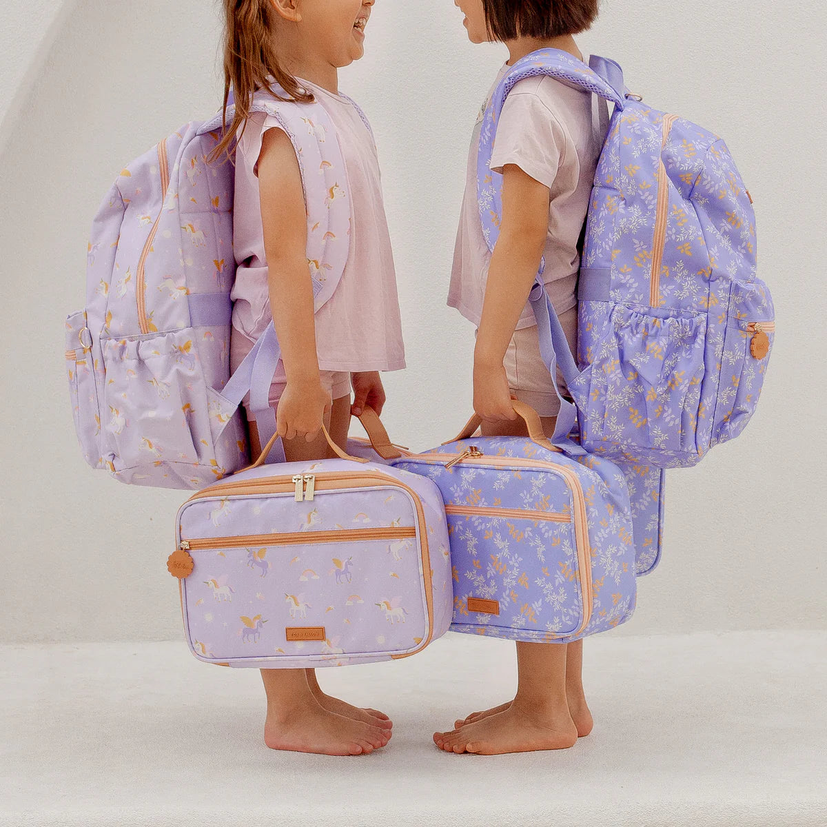 kids wearing unicorn and Fox & Fallow backpack for kids, perfect for school, daycare and everyday use. Spacious, practical and designed for little adventures. Personalisation of embroidery with name also available on bags in 2 placements. This print is juniper - lilac purple with leaves