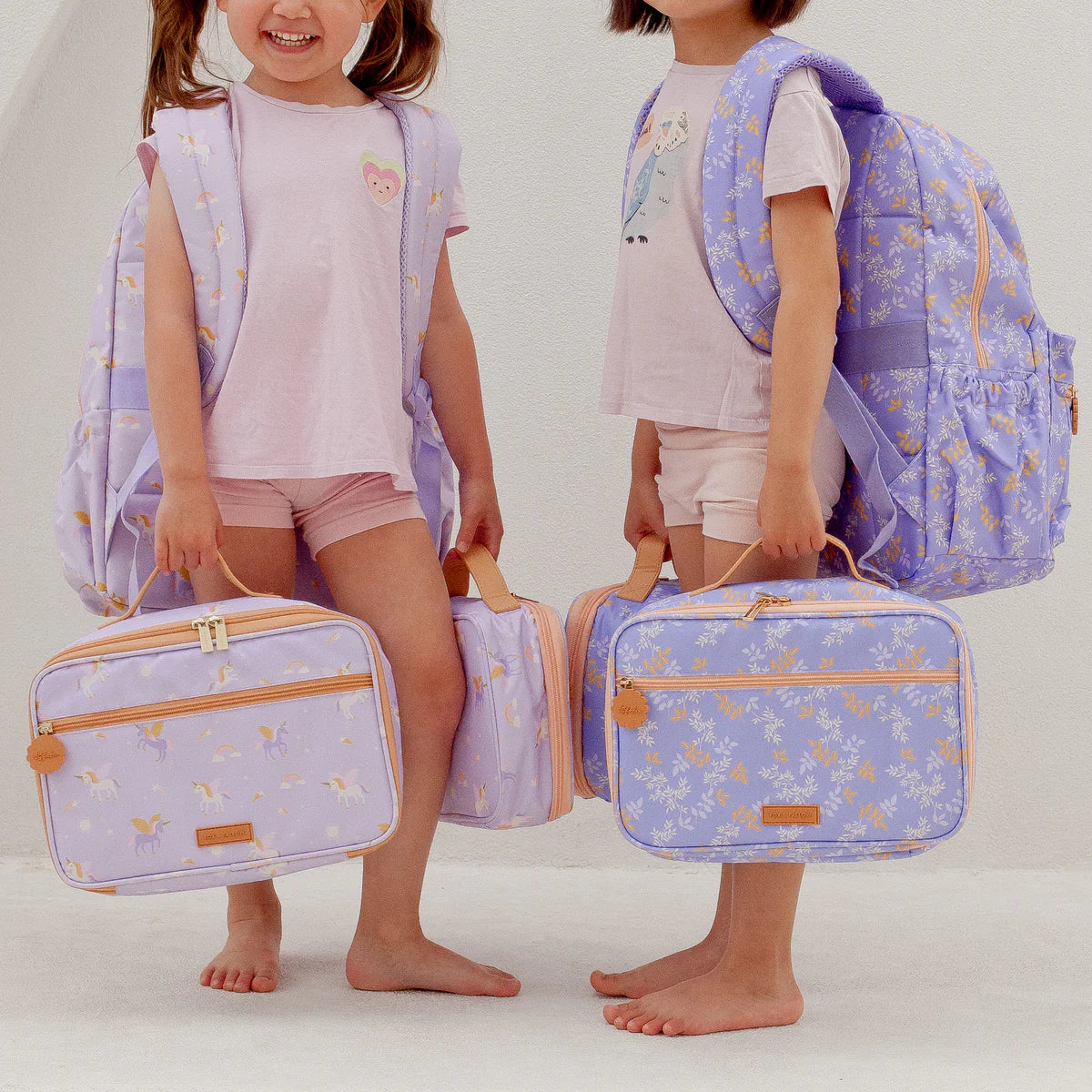 side view of child wearing Fox & Fallow backpack for kids, perfect for school, daycare and everyday use. Spacious, practical and designed for little adventures. Personalisation of embroidery with name also available on bags in 2 placements. This print is juniper - lilac purple with leaves