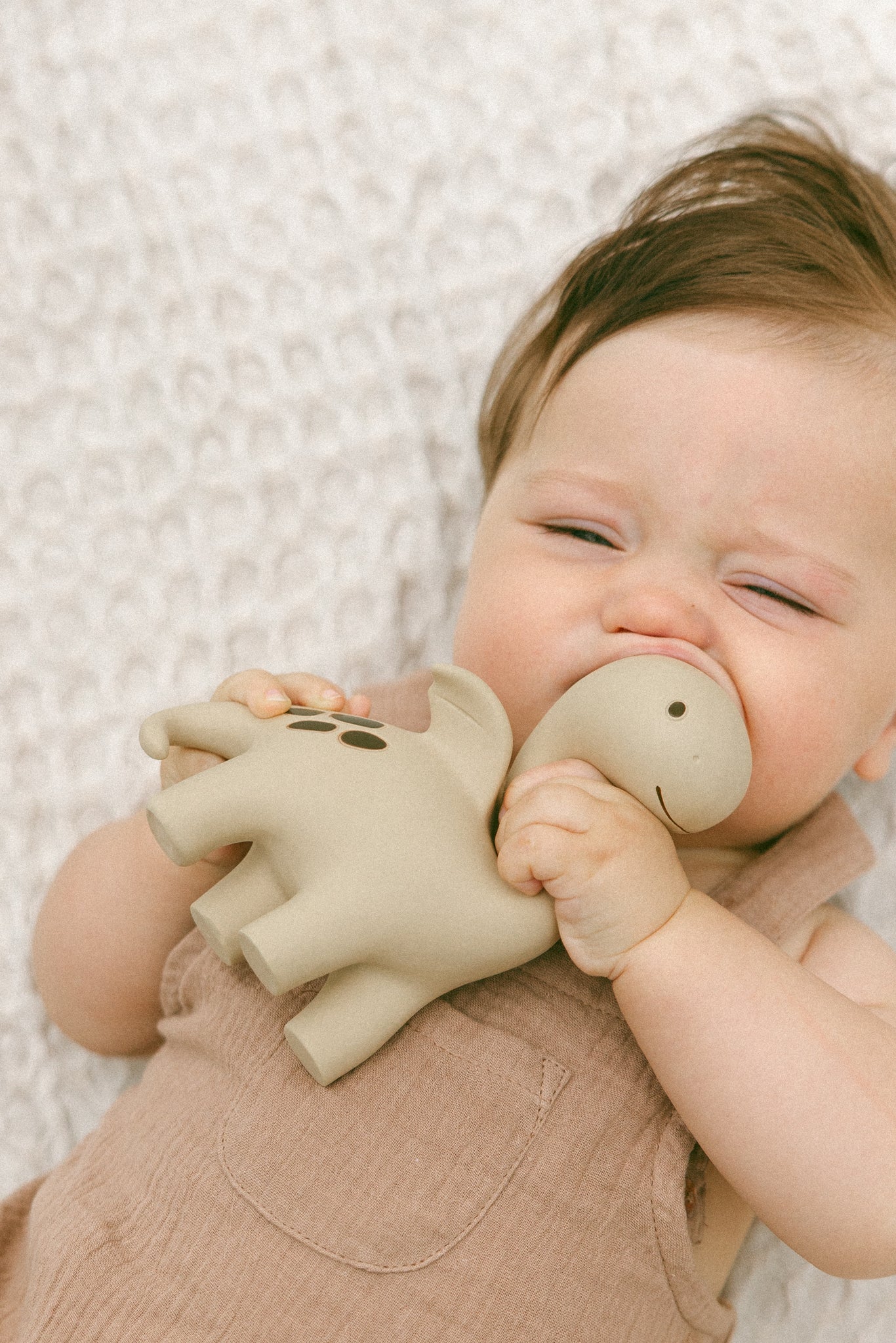 Natural rubber dinosaur teether for babies in sage by Winnie Parkes