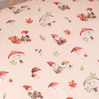 Close up of Gnomes organic cotton fitted cot sheet showing playful woodland gnome print on soft breathable jersey fabric