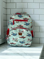 photoshoot front view of Mini & Mum kids backpack with insulated interior for daycare and outings. can be personalised with childs name. this print is aviator wonders - blue sky with clouds and planes