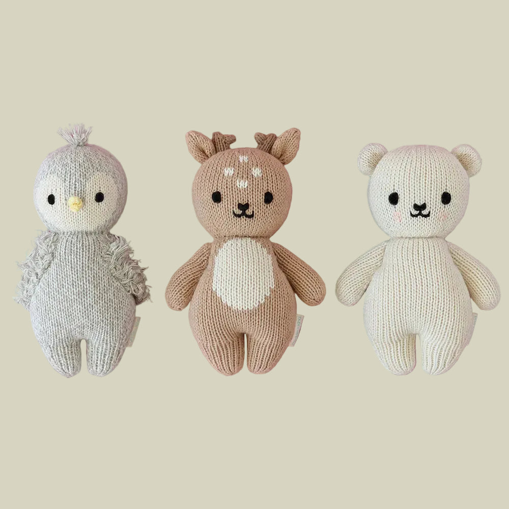 Cuddle+Kind baby animal collection of hand knit plush toys including baby fawn, baby bear and baby penguin friends