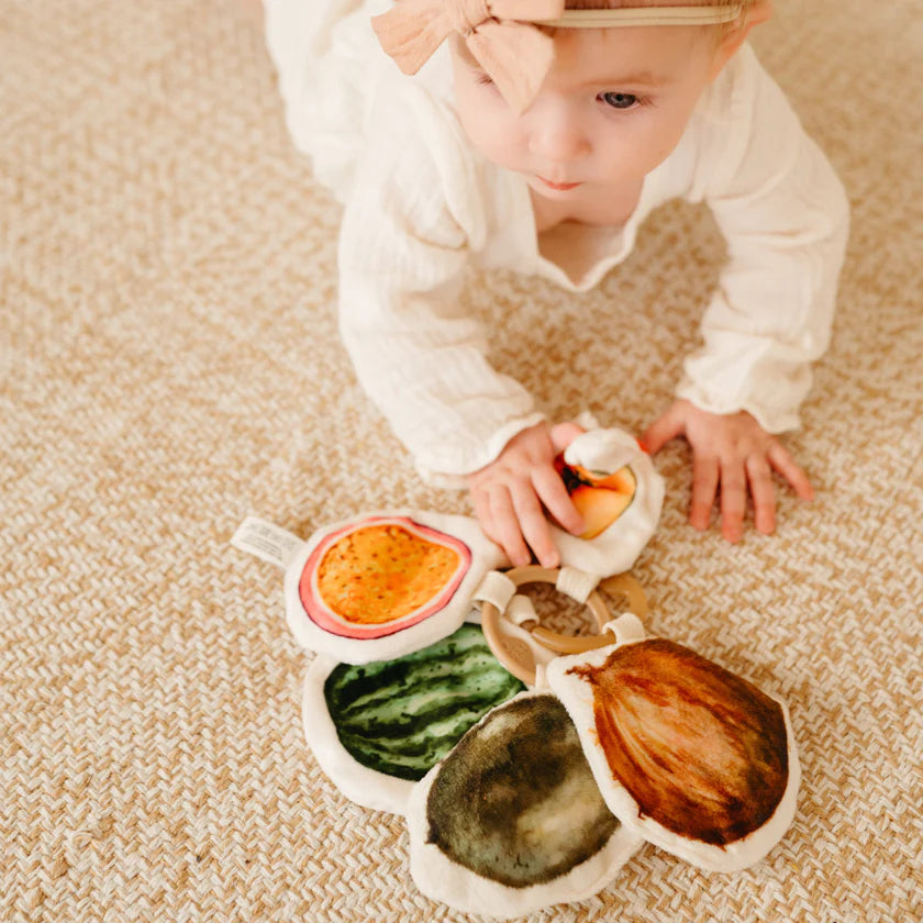 baby exploring soft tropical fruit toys sensory development
