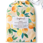 Snuggle Hunny Sunny Citrus organic bassinet sheet in matching drawstring bag featuring bright lemon and citrus fruit print