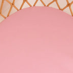 Close up of Bubblegum organic cotton bassinet sheet showing smooth pink stretch jersey fabric and soft breathable texture