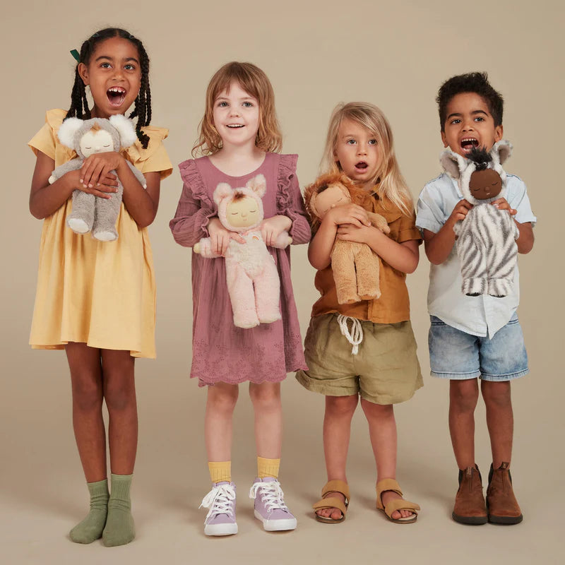 children holding Olli Ella Cozy Dinkum dolls including Mini Zebra