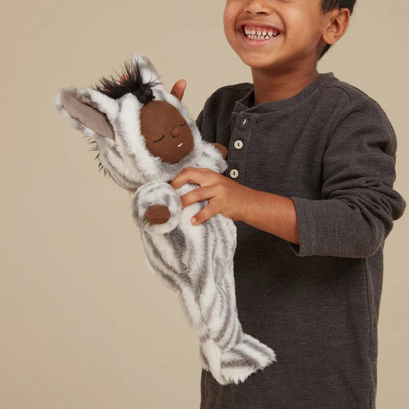 Child holding Mini Zebra Cozy Dinkum doll Olli Ella