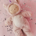 Pink unicorn Cozy Dinkum doll styled on soft pink background