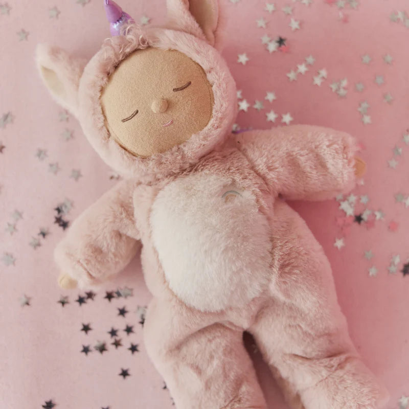 Pink unicorn Cozy Dinkum doll styled on soft pink background