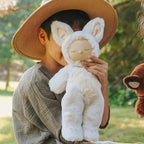 Child holding Fenix Fox Cozy Dinkum doll Olli Ella