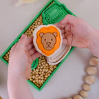 showing completed image of playdough/clay stamp and cutter. Eco-friendly sensory play tool by brand playsense perfect for creative and imaginative play. can also be used for cookies and baking. pictured is lion