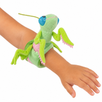 Plush toy grasshopper on a child's wrist against a white background