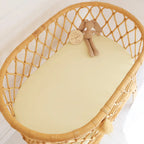 Snuggle Hunny Lemon Sorbet organic fitted bassinet sheet on woven bassinet mattress in soft yellow cotton jersey