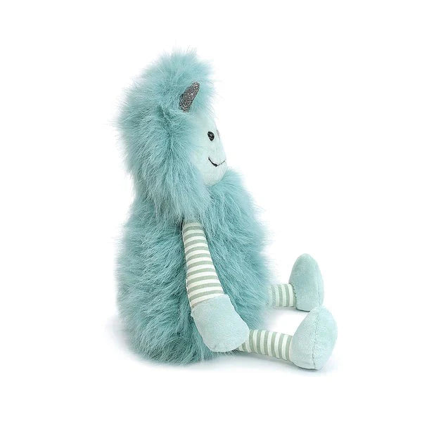 side view of turquoise edgar monster with striped legs and arms, made by the brand mon ami. friendly soft plush