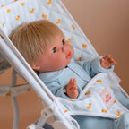 close up photo of baby doll kids stroller for pretend play with mini coletto doll inside. made by brand tiny harlow. print pictured is blue ducky