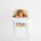 sherpa highchair for dolls made by tiny harlow with a doll inside