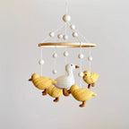 Handmade duck baby mobile with mama duck and fluffy ducklings for nursery décor by Ganapati