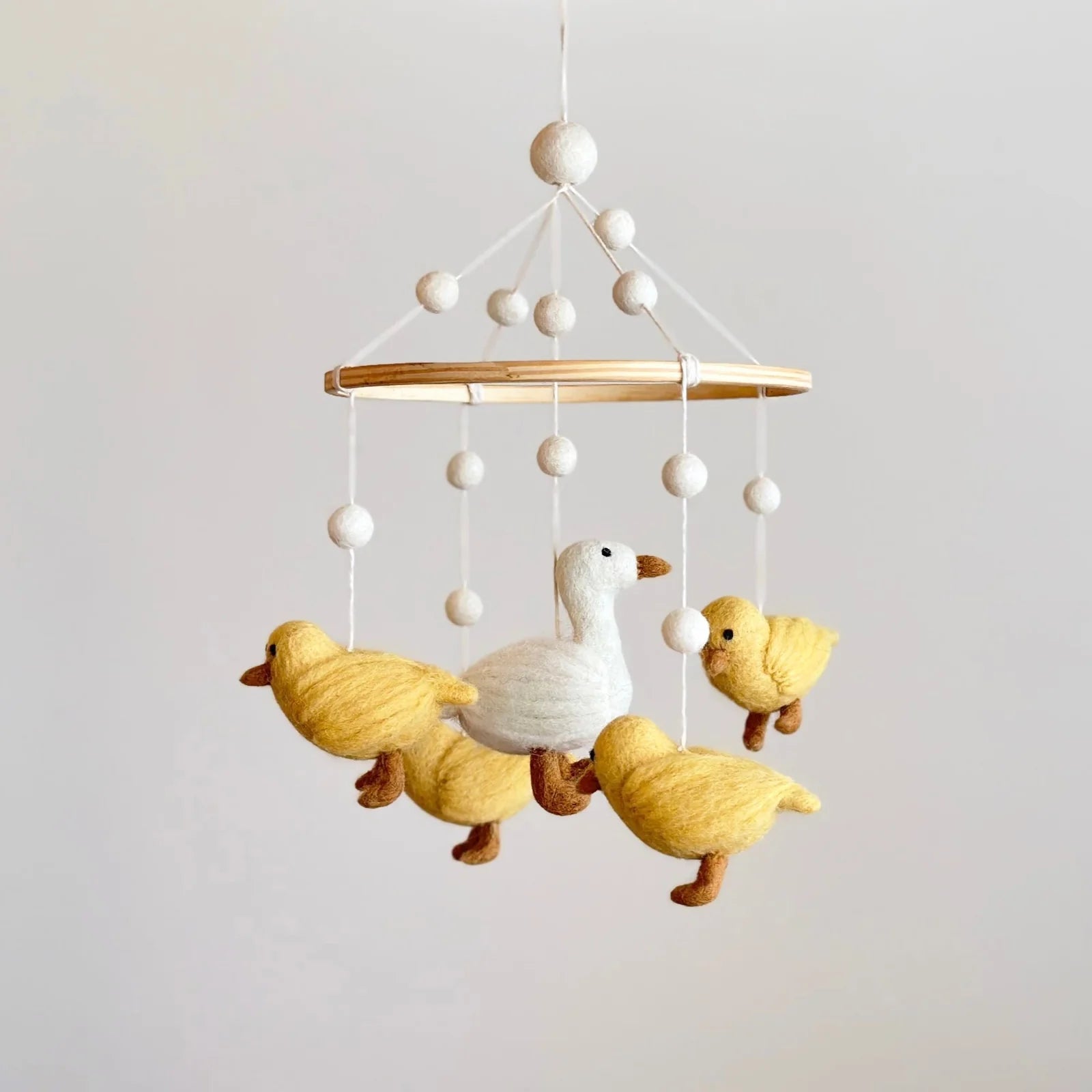 Handmade duck baby mobile with mama duck and fluffy ducklings for nursery décor by Ganapati