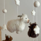 close up of white highland cow on nursery cot mobile