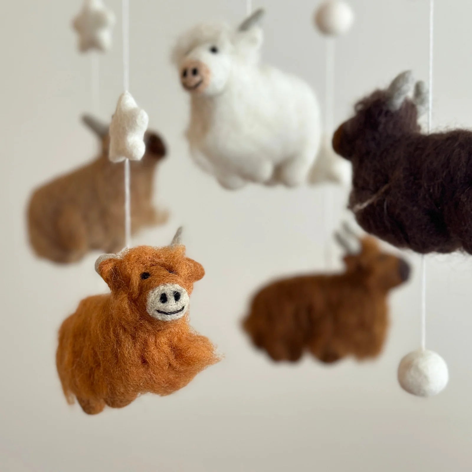close up highland cow on felt cot mobile