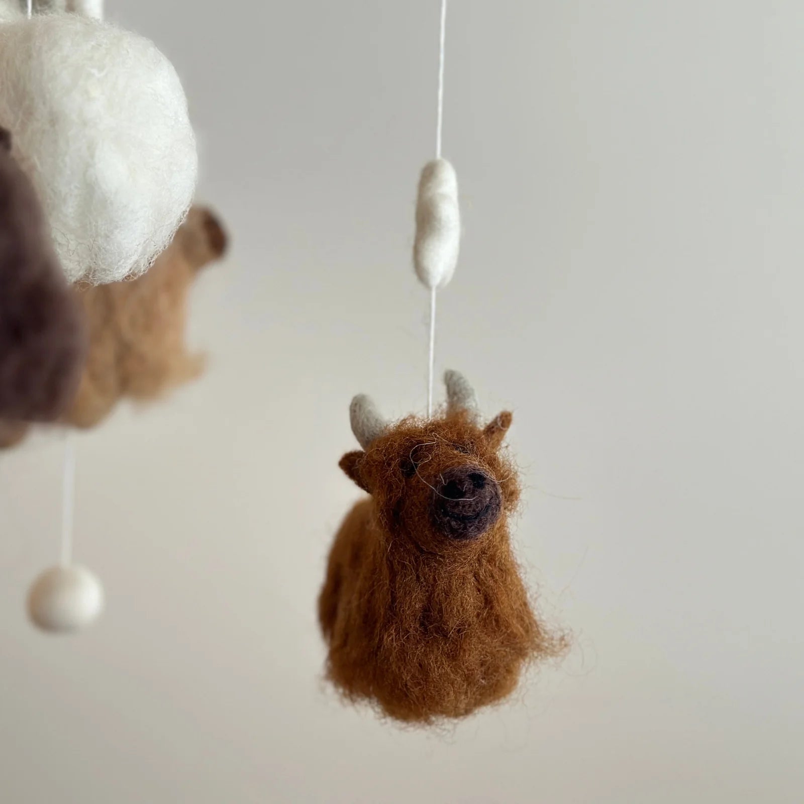 close up highland cow felt mobile