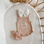 She’s Here newborn knit romper bundle by Blossom and Pear with matching booties and topknot headband