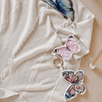 baby lying under play gym with hanging butterfly sensory toys