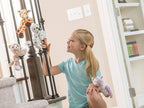child showing off huggers snap band animals on staircase by wild republic