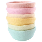 Pastel felt bowls used in sensory play setup with loose parts