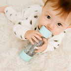 Jellystone Designs sensory bottle for babies in soft mint with floating silver and pastel sparkles