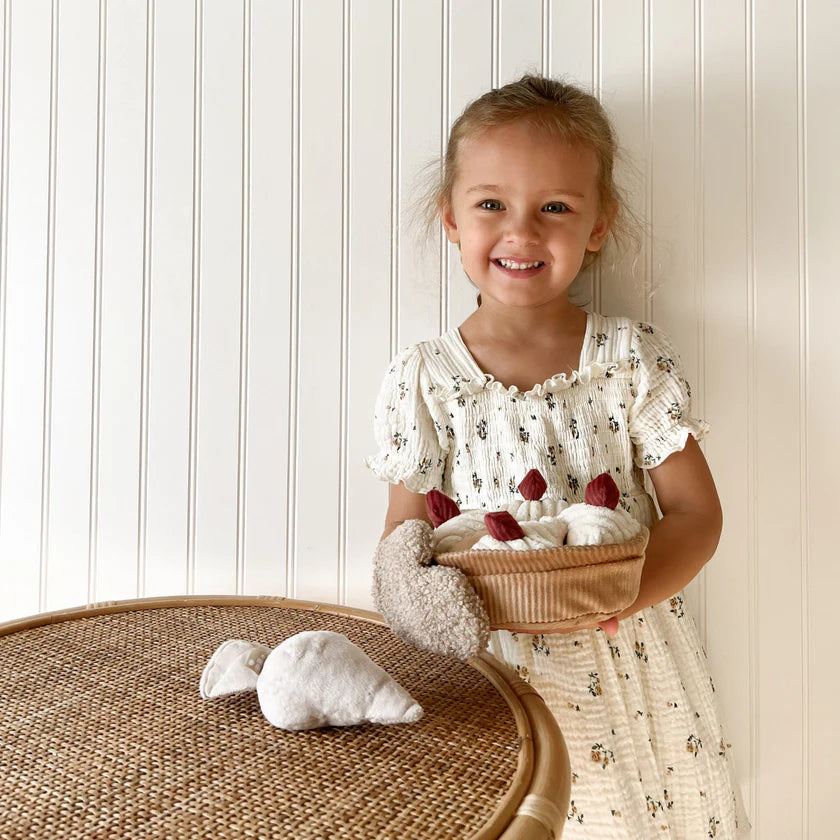 Little Lamb Kind pretend baking toy set featuring plush cake slices, oven mitt and baking accessories
