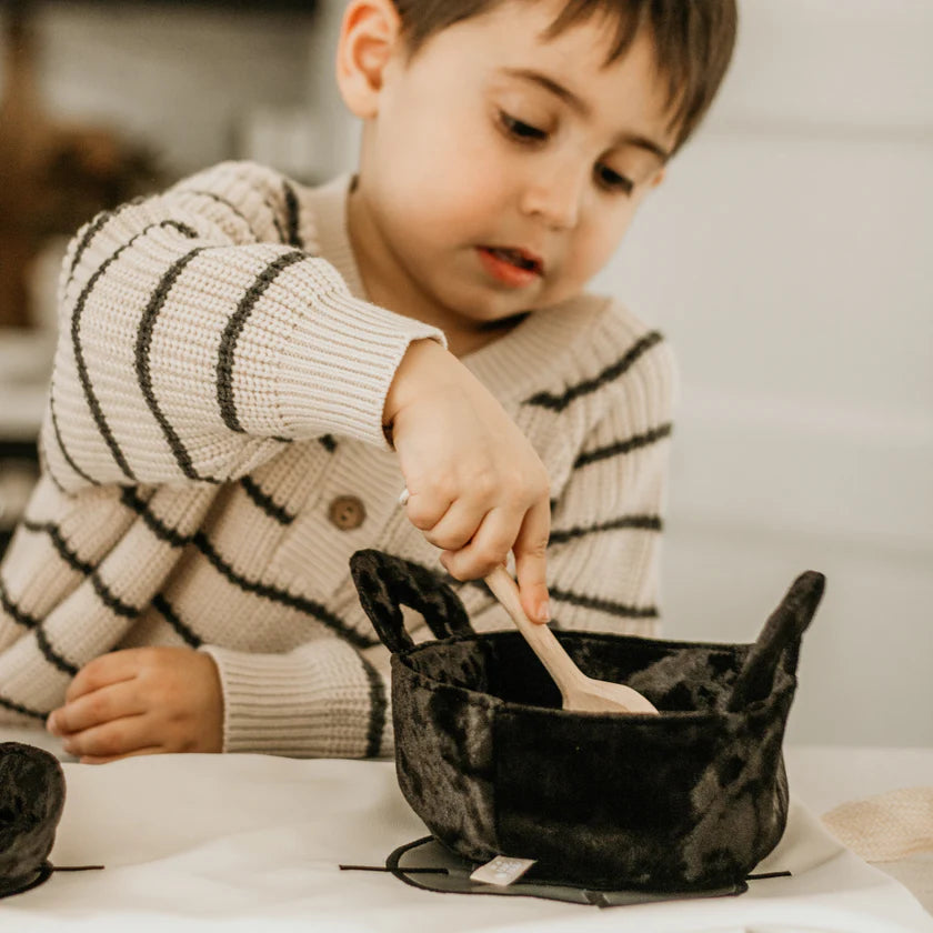 Child using soft pretend cookware from Little Lamb Kind kitchen set