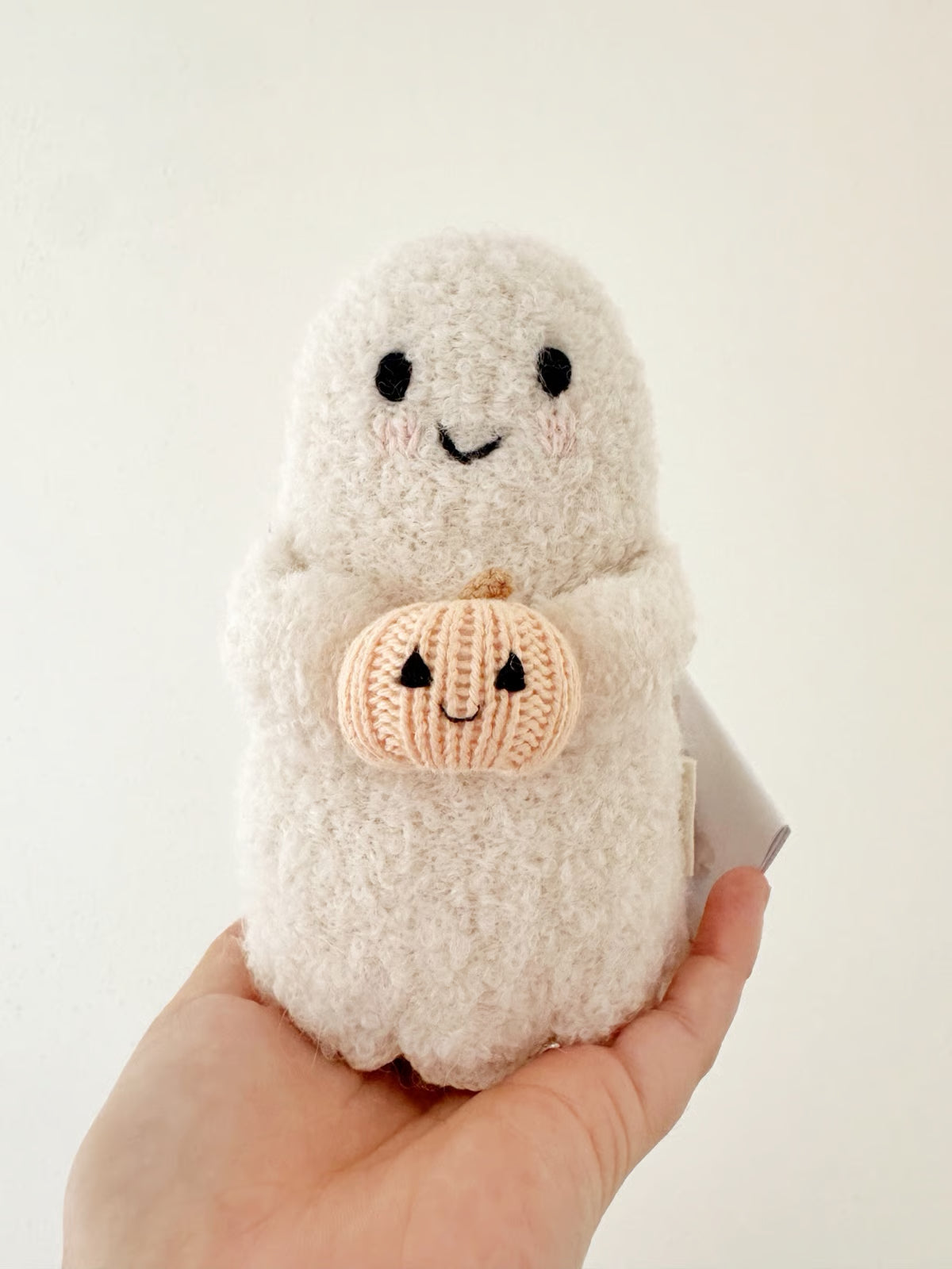 Handmade ghost doll holding a pumpkin